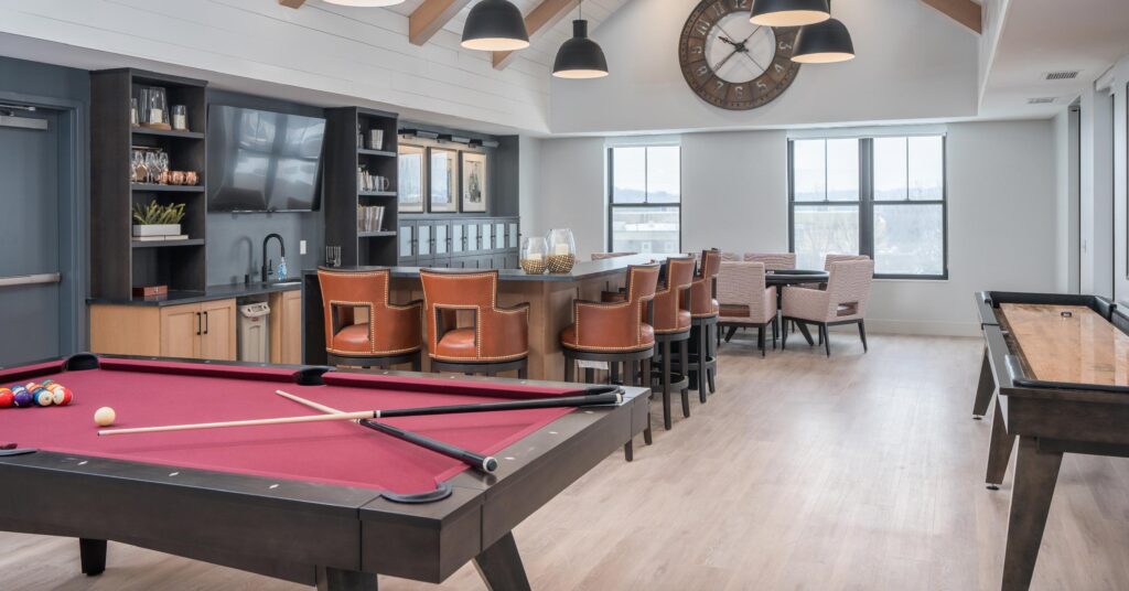 A common room at Lake Place apartments featuring a pool table
